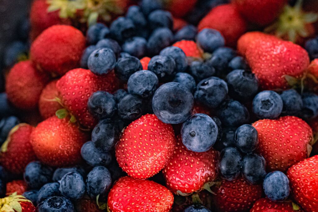 Vibrant close-up of fresh strawberries and blueberries displaying natural texture and freshness.